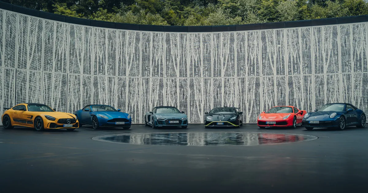 A selection of luxury supercars sits in a semi-circle on an HunterMoss motoring experience.
