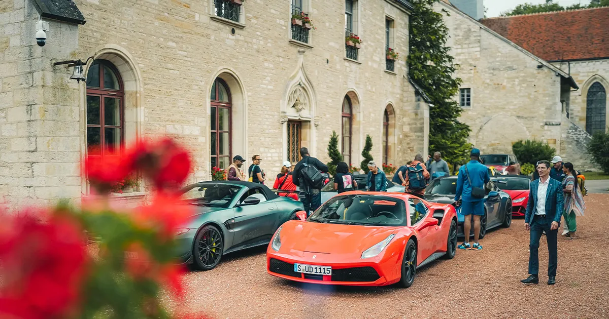 The HunterMoss fleet of supercars parked outside a huge French manor house.