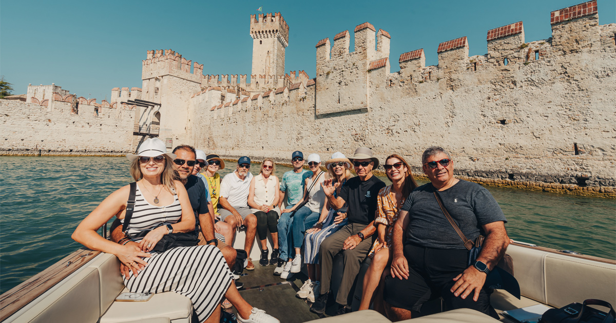 A happy group of guests on a boat exploring an ancient castle with HunterMoss
