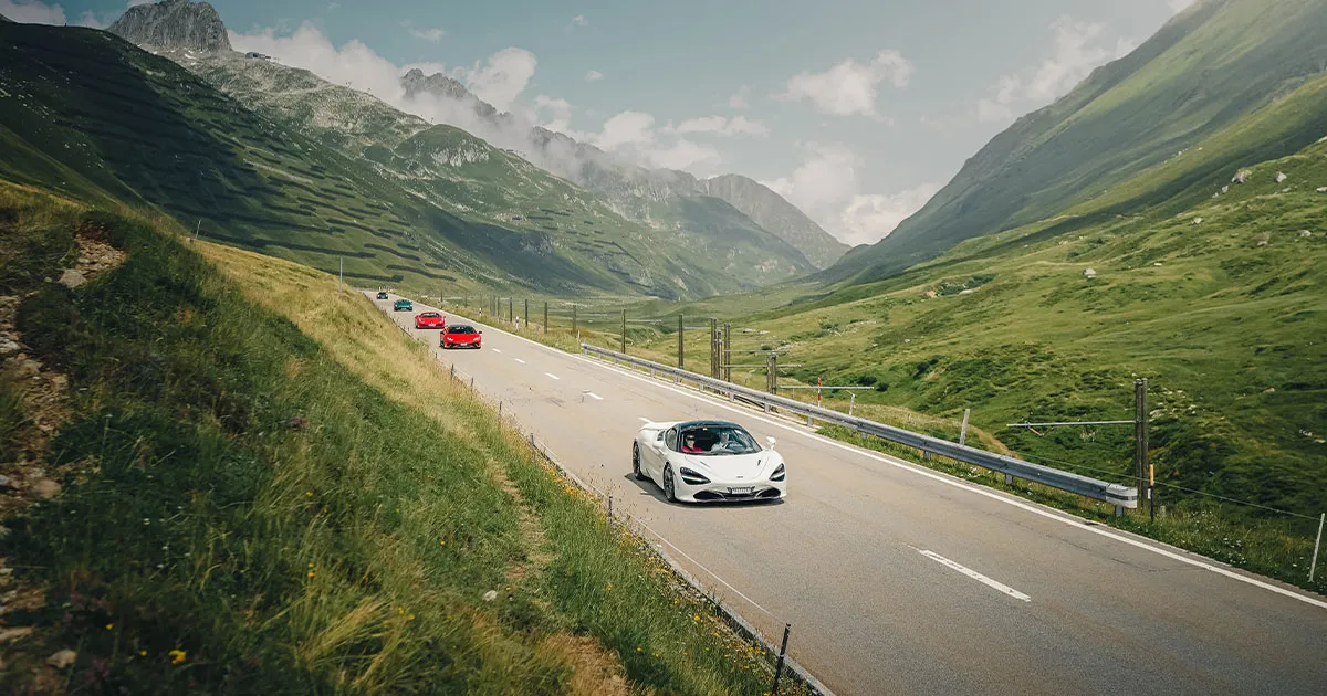A convoy of HunterMoss supercars led by a white McLaren 720S