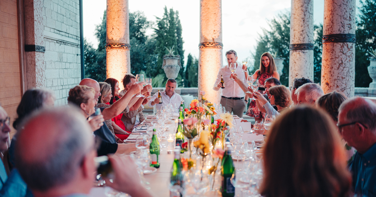 HunterMoss guests share a toast at an elegant al fresco dinner table