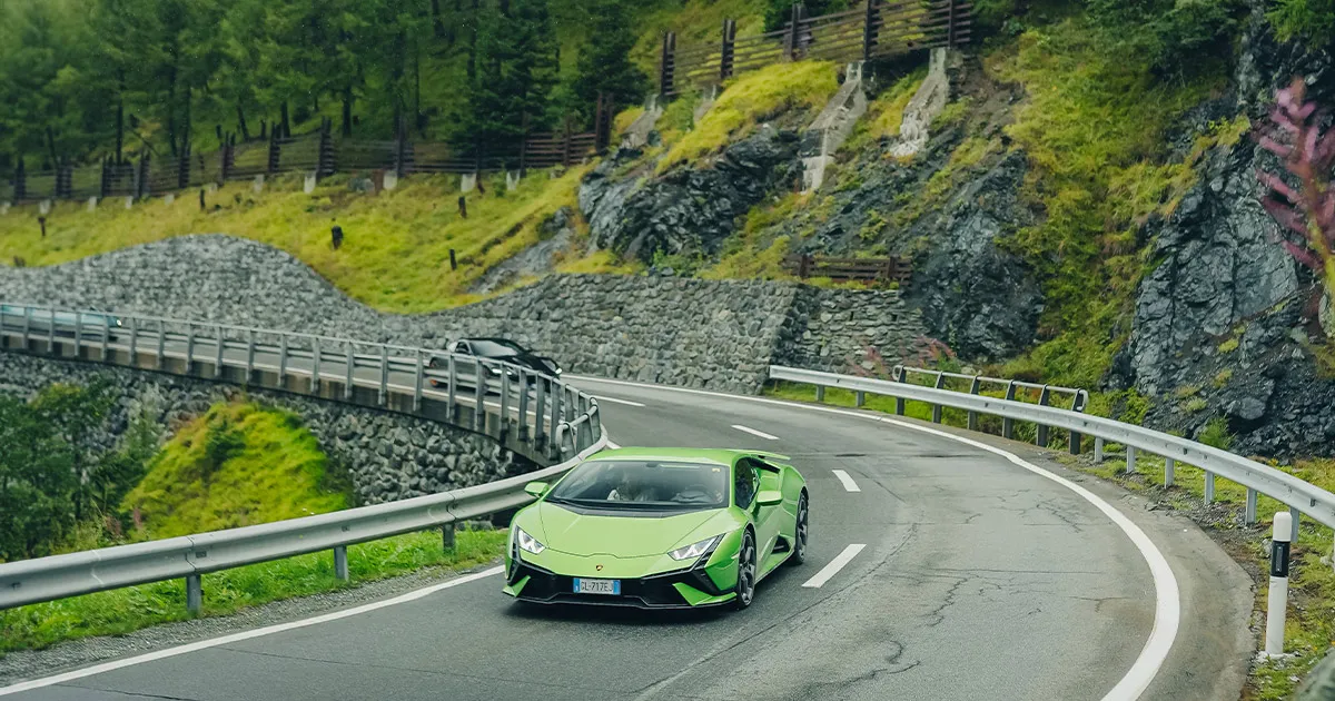 A green Lamborgini Huracán carves up a sweeping corner on an HunterMoss journey