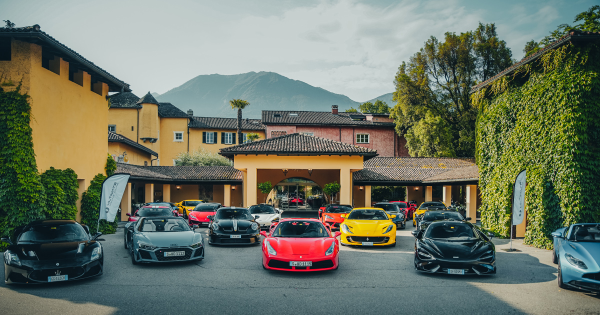 The HunterMoss fleet of supercars parked outside a large yellow luxury villa at Castello del Sole