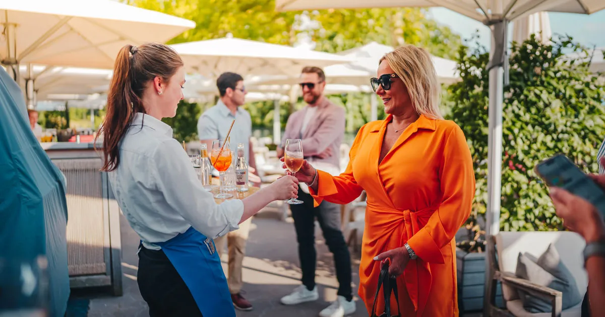 Fashionably dressed guests enjoying cocktails on an HunterMoss tour.