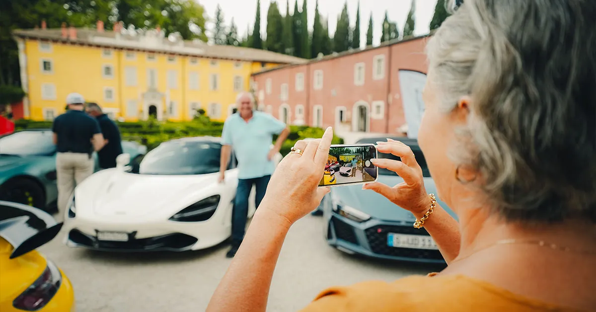 HunterMoss guests pose for a photo in front of supercars.