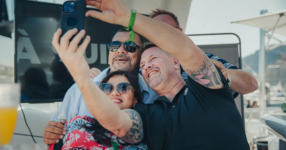 Two men and a woman snap a happy selfie on an HunterMoss luxury tour.