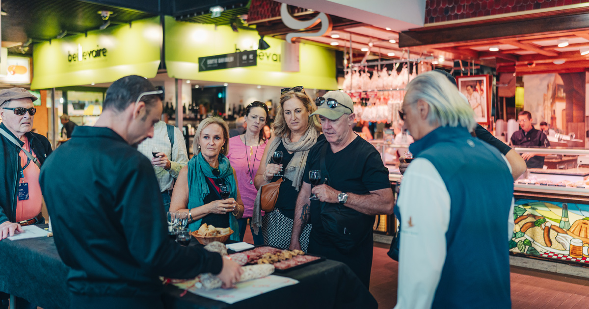 A group of HunterMoss guests taste wine and platters at Halles de Lyon