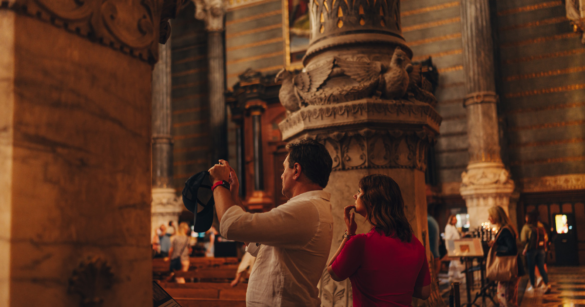 A man and woman taking pictures of Lyon’s architecture as part of an HunterMoss experience