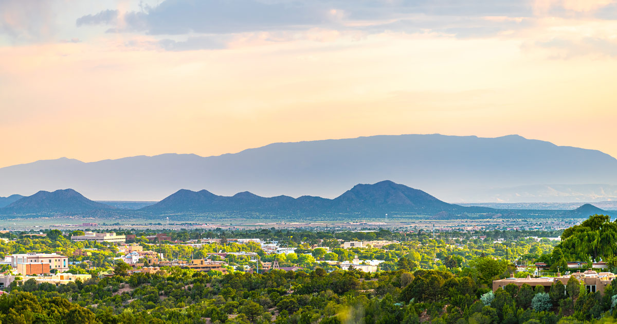 Stunning hazy skies are a New Mexico signature. Mountains and foothills behind the Santa Fe cityscape on a hazy day