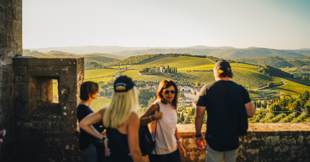 HunterMoss’ guests admire a panorama of rolling green valleys in Tuscany from a balcony