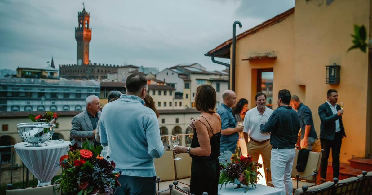 HunterMoss’ guests chatting with drinks on a rooftop in Florence