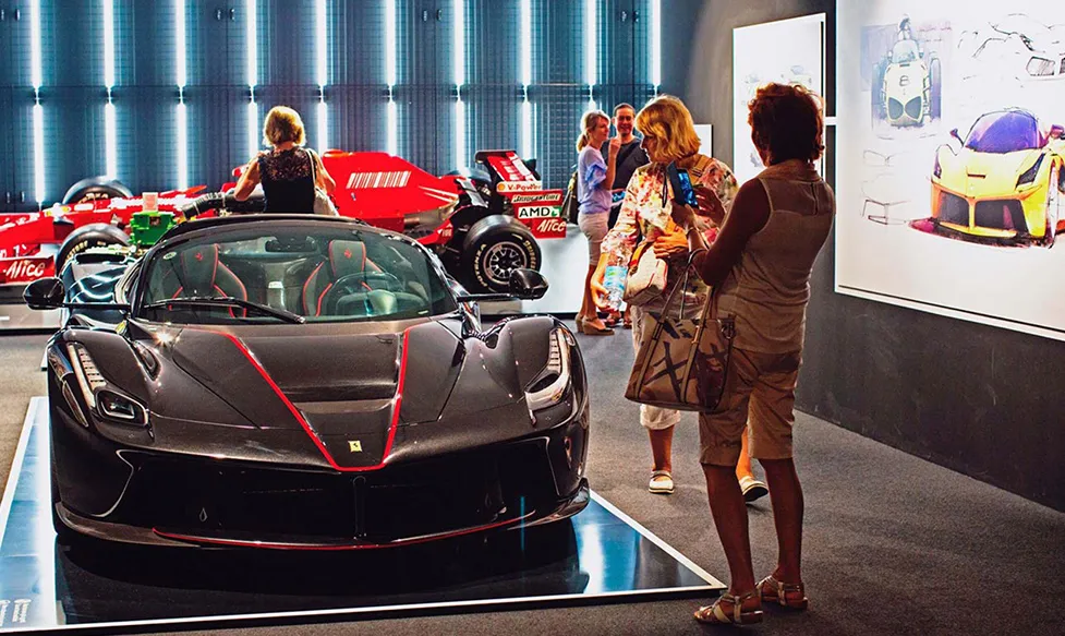 HunterMoss’; guests take photos of a rare prototype car at Ferrari’s famous Maranello factory in Italy