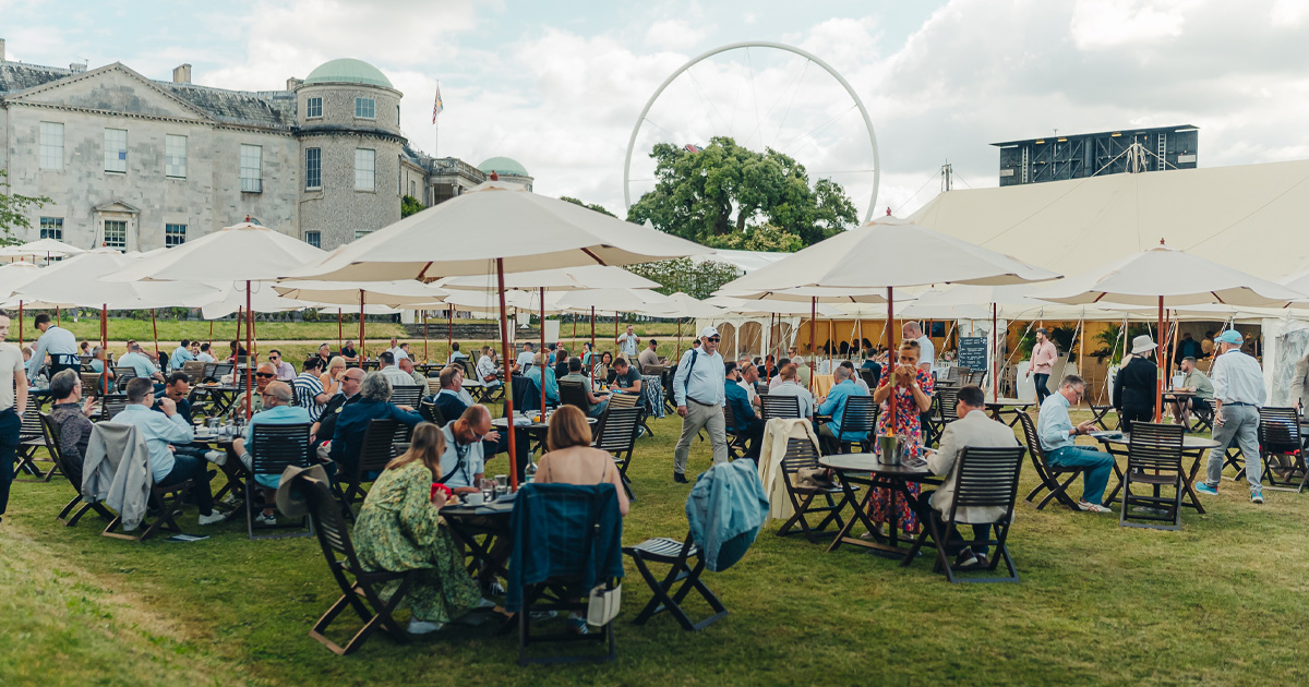 Guests sit at outdoor tables on the lawn at Goodwood Festival of Speed.