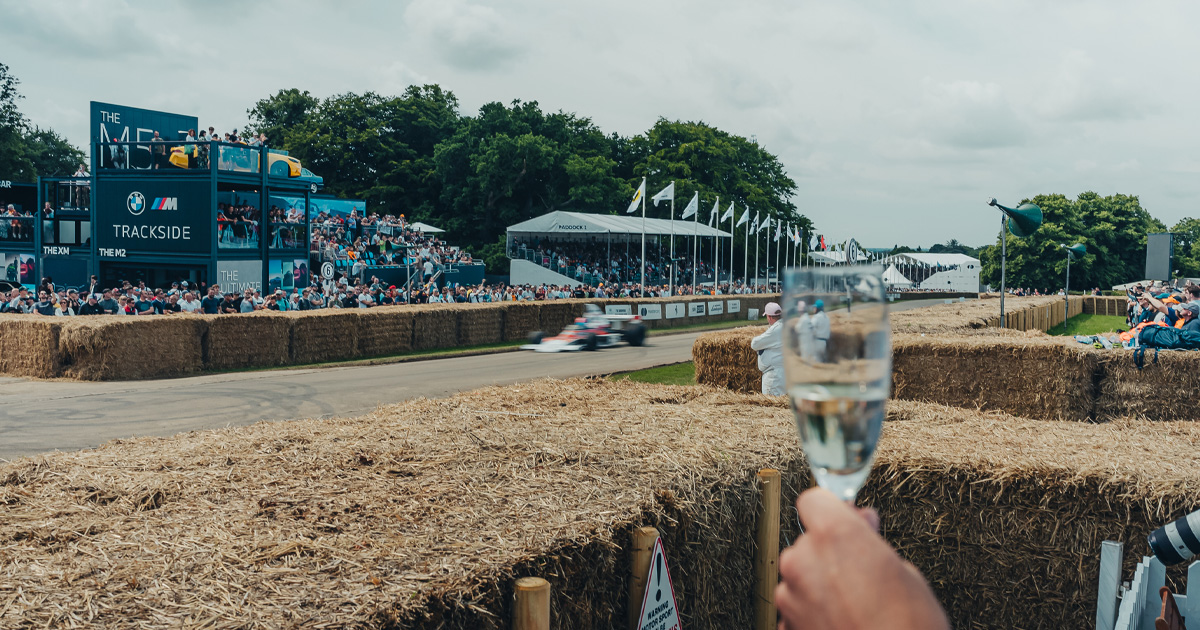 A vintage F1 car rounds a corner at Goodwood Festival of Speed