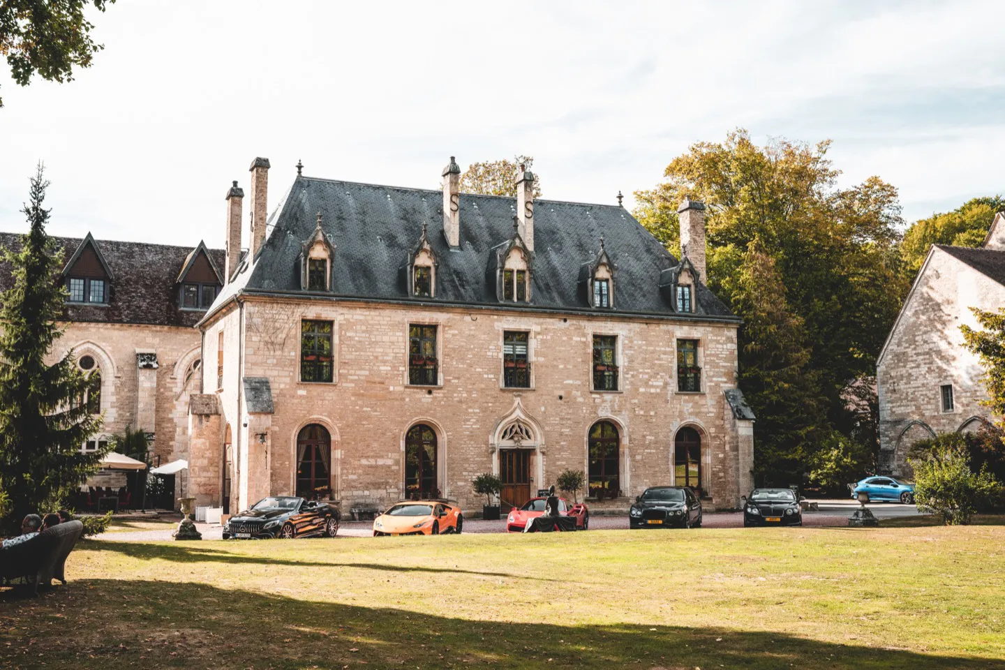 Supercars parked in front of five-star hotel in Burgundy on a luxury holiday