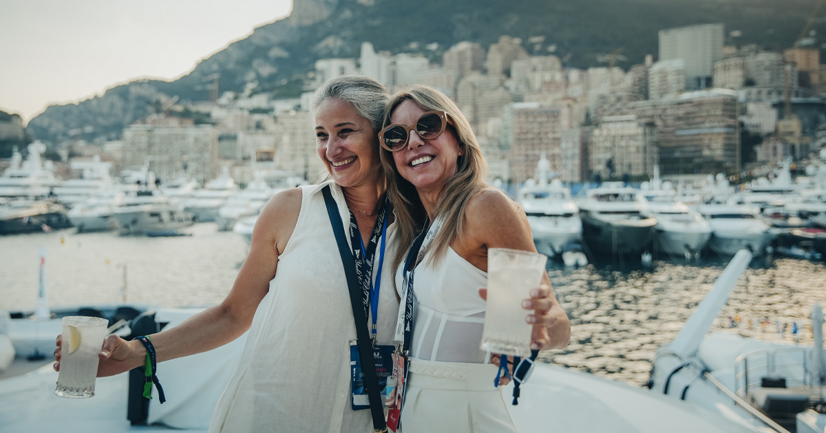 Two women in a happy embrace on the Monte Carlo Harbour for Monaco Grand Prix