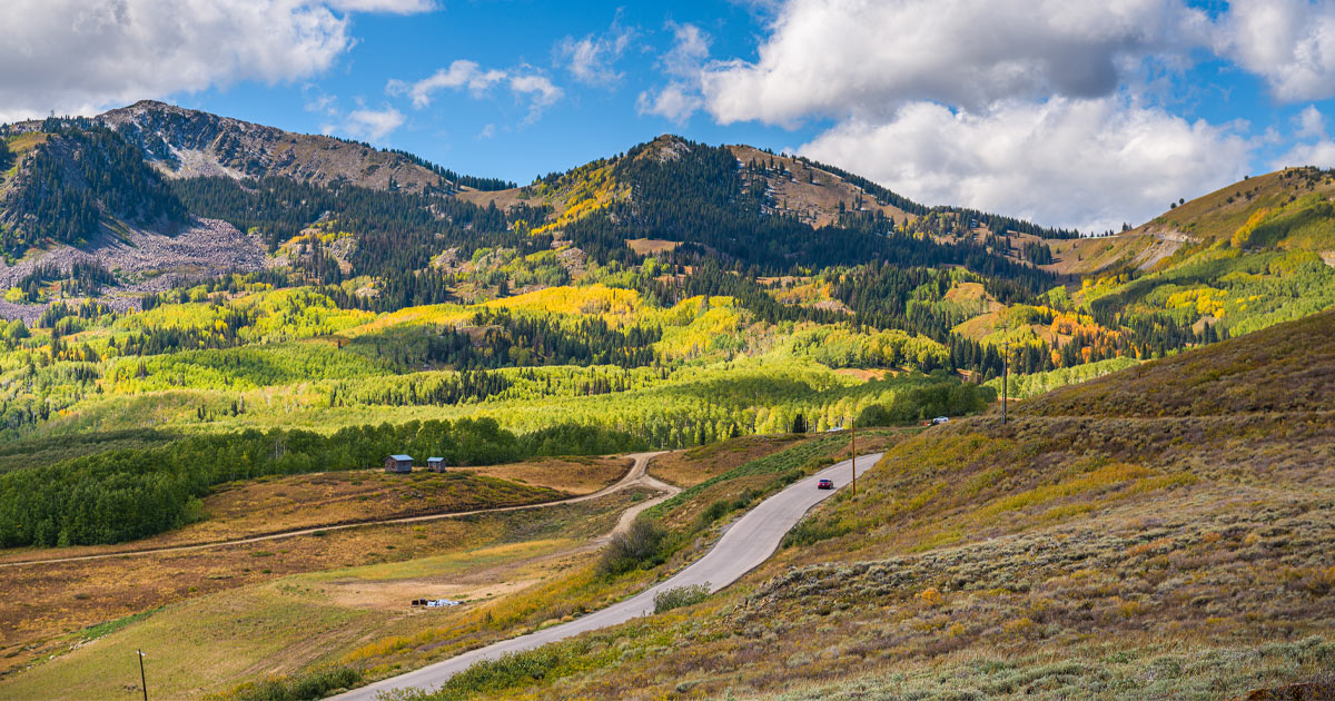 A country backroad in Deer Valley surrounded by rolling hills and evergreen forests
