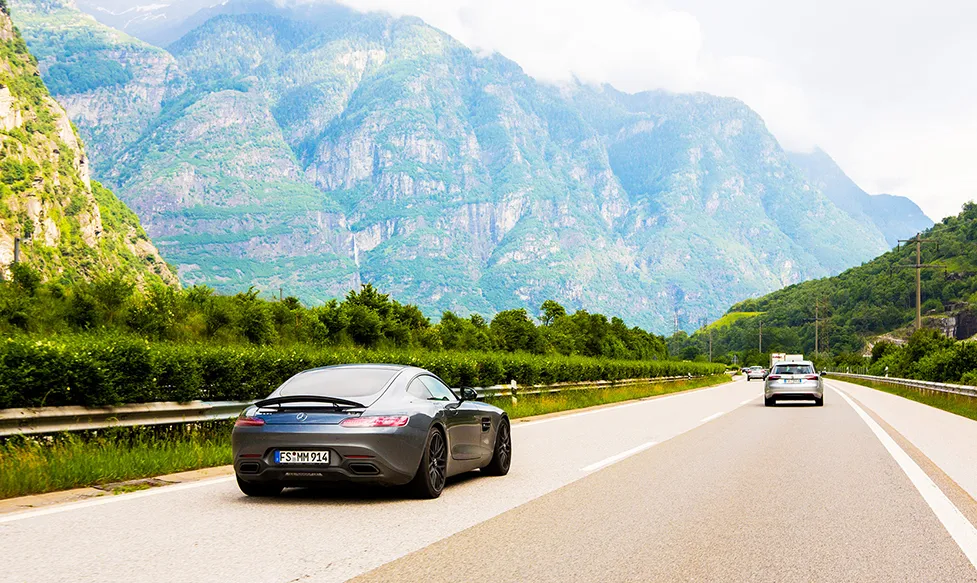 A grey Mercedes GTR, seen from the rear, on a highway during an HunterMoss luxury holiday