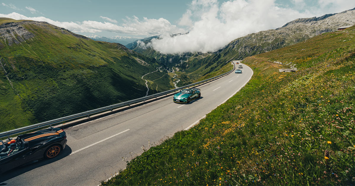 A green Aston Martin Vantage in the middle of a supercar convoy for HunterMoss