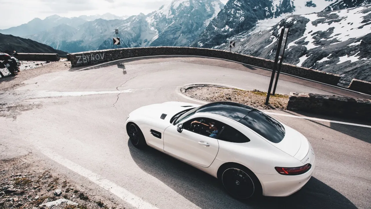 Taking a sharp turn on Stelvio Pass, Italy in one of the HunterMoss supercars