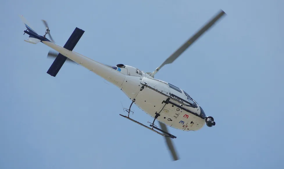 A helicopter, seen from below, as it transports HunterMoss’ guests to the race at Monaco