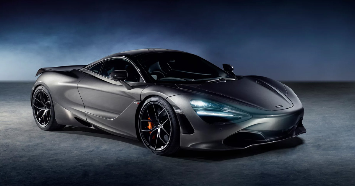 Poised and ready for action. A gunmetal grey McLaren 720S with its LED headlights on