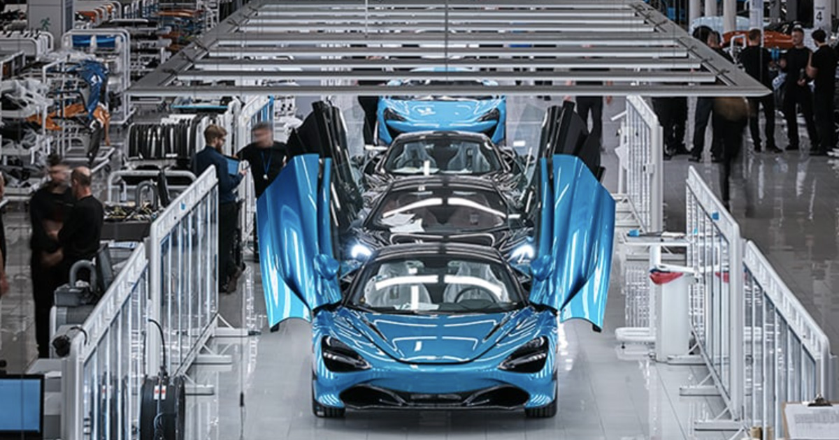 \"One in blue and one in black for me, please.\" McLaren supercars move along a spotless factory line as workers perform checks and processes