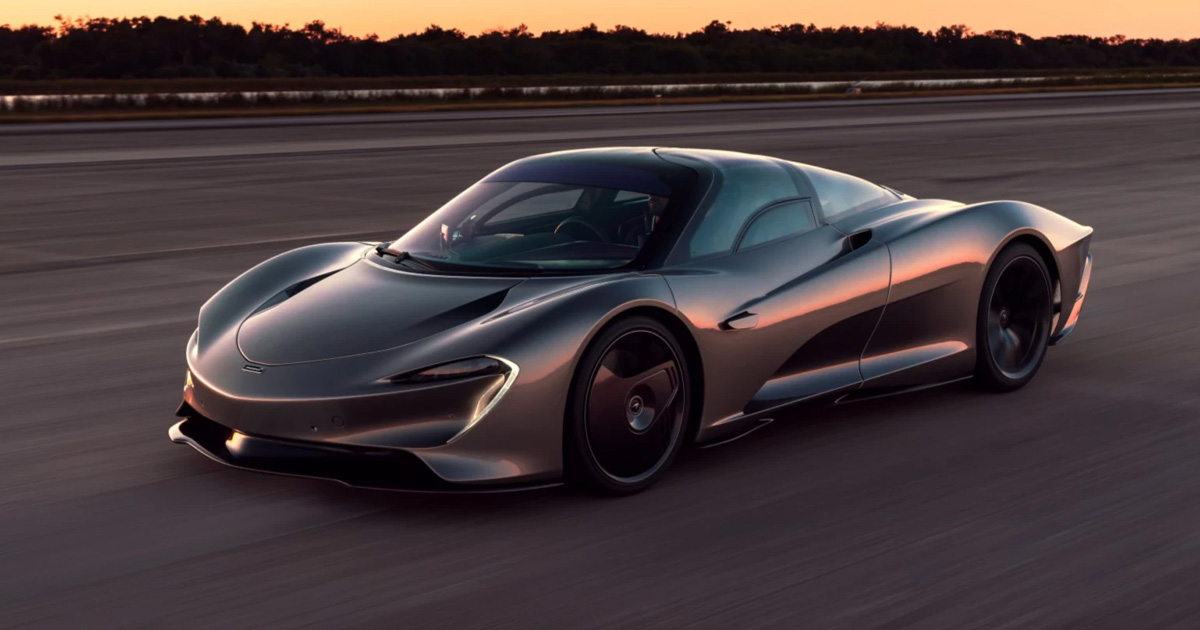 There isn't a straight edge in sight on the flowing lines of the Speedtail. A McLaren Speedtail supercar driving on a closed road at dusk.